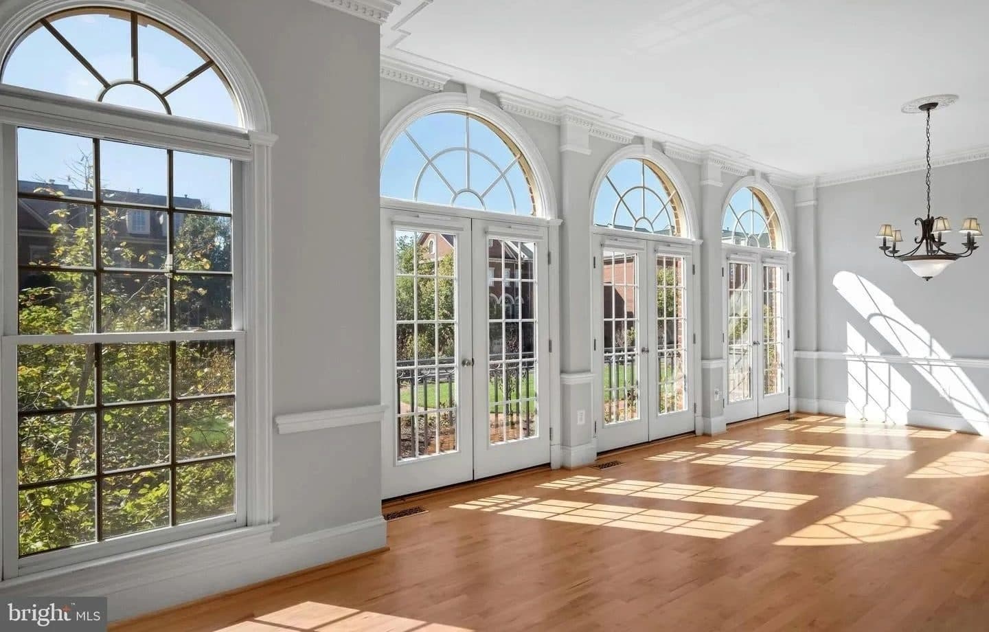 Cameron Station townhouse entry with arched doorway and hardwood staircase