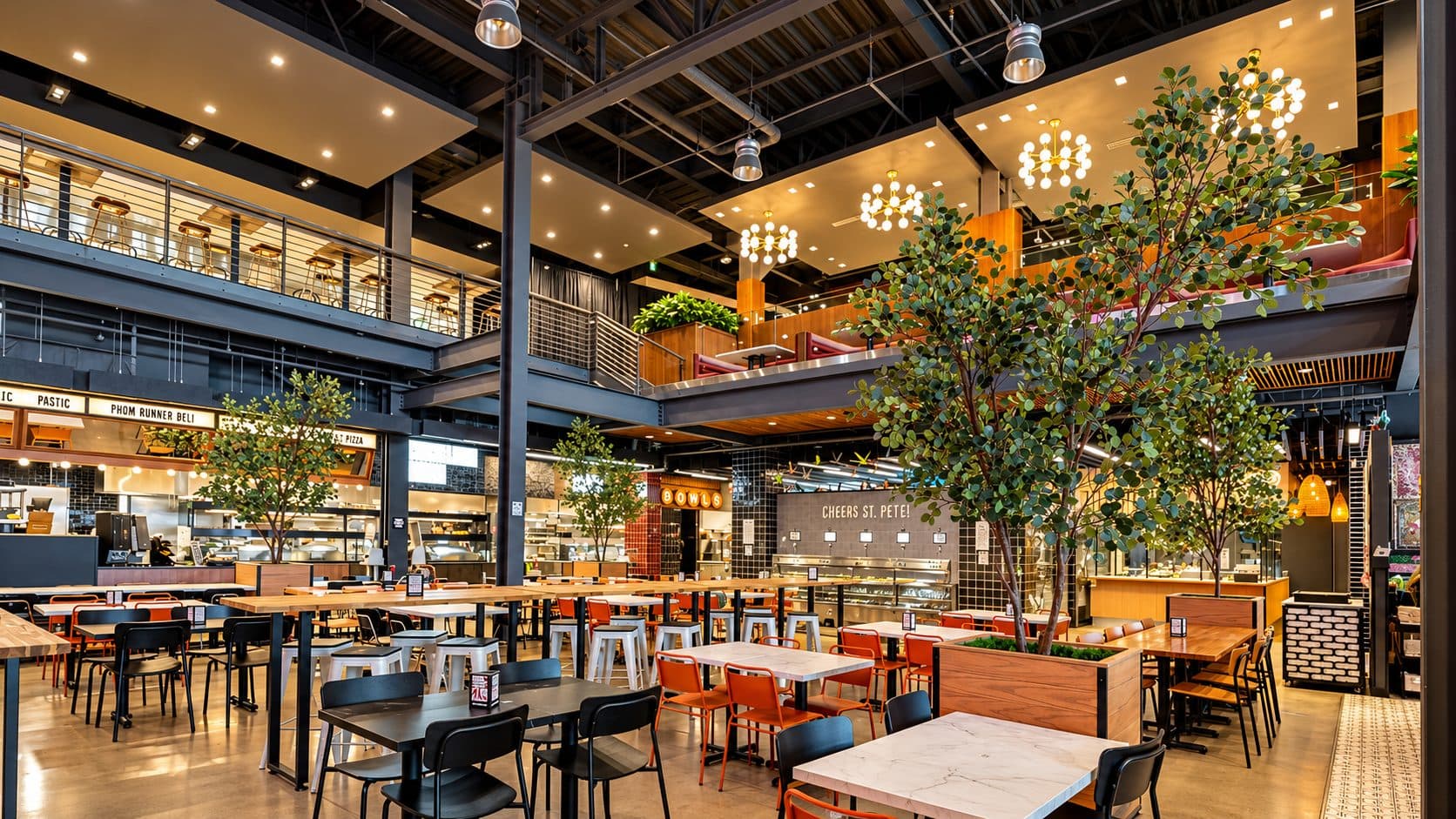 Central Park Food Hall double-height dining hall with mezzanine and indoor trees