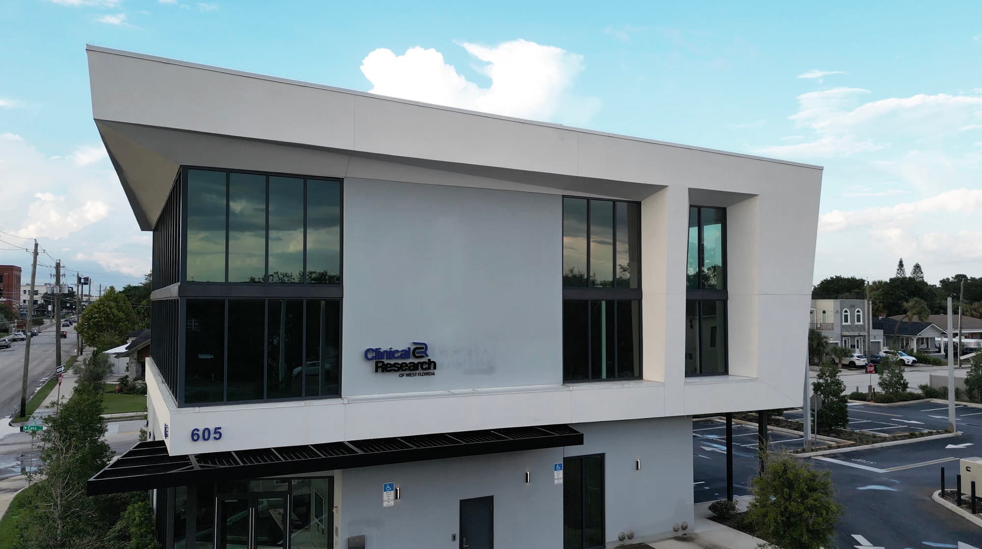 Clinical Research Office 2 exterior facade with white paneling and dark-framed glass curtain wall