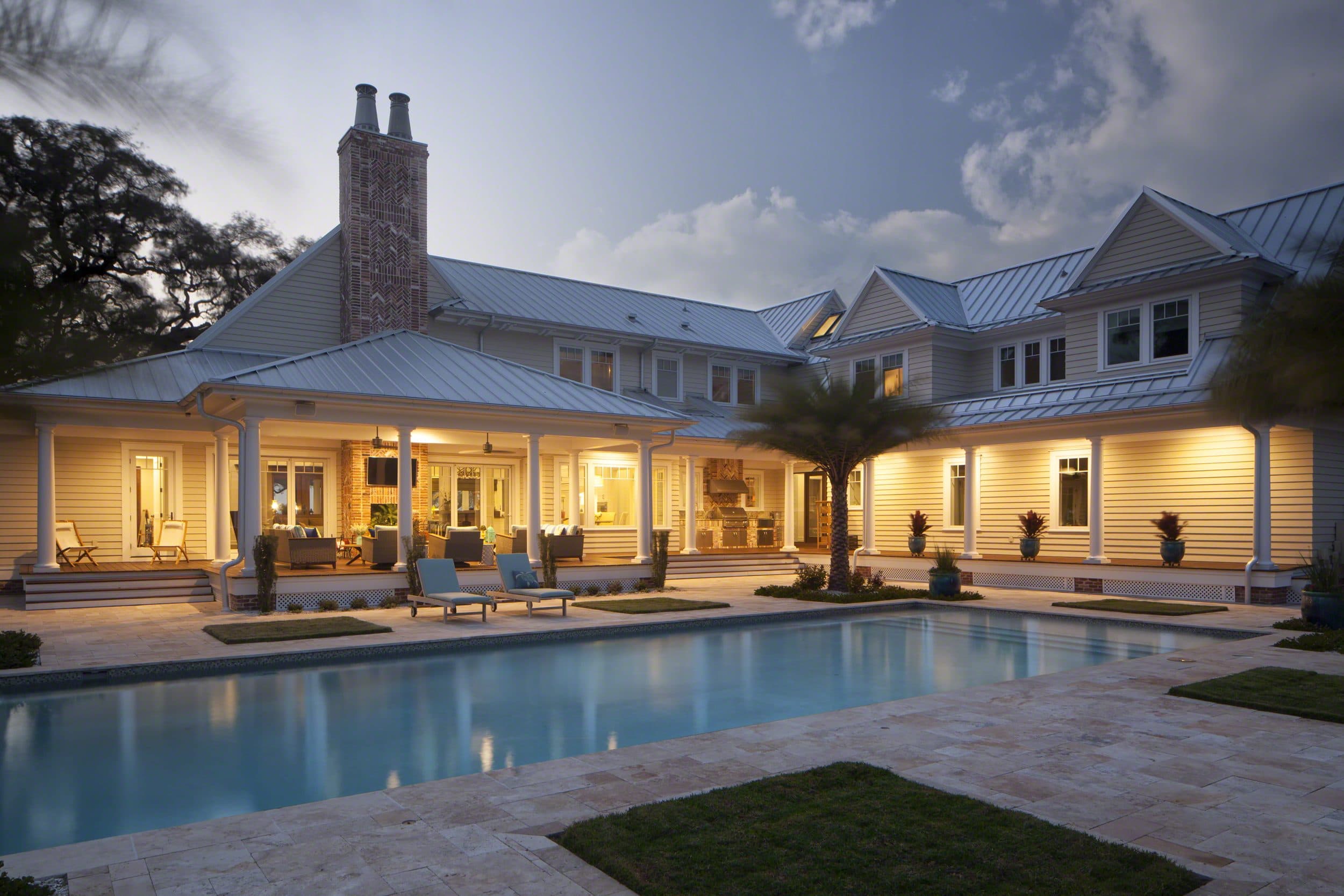 Old Bay Residence rear pool terrace and covered loggia at dusk with outdoor kitchen and bay views