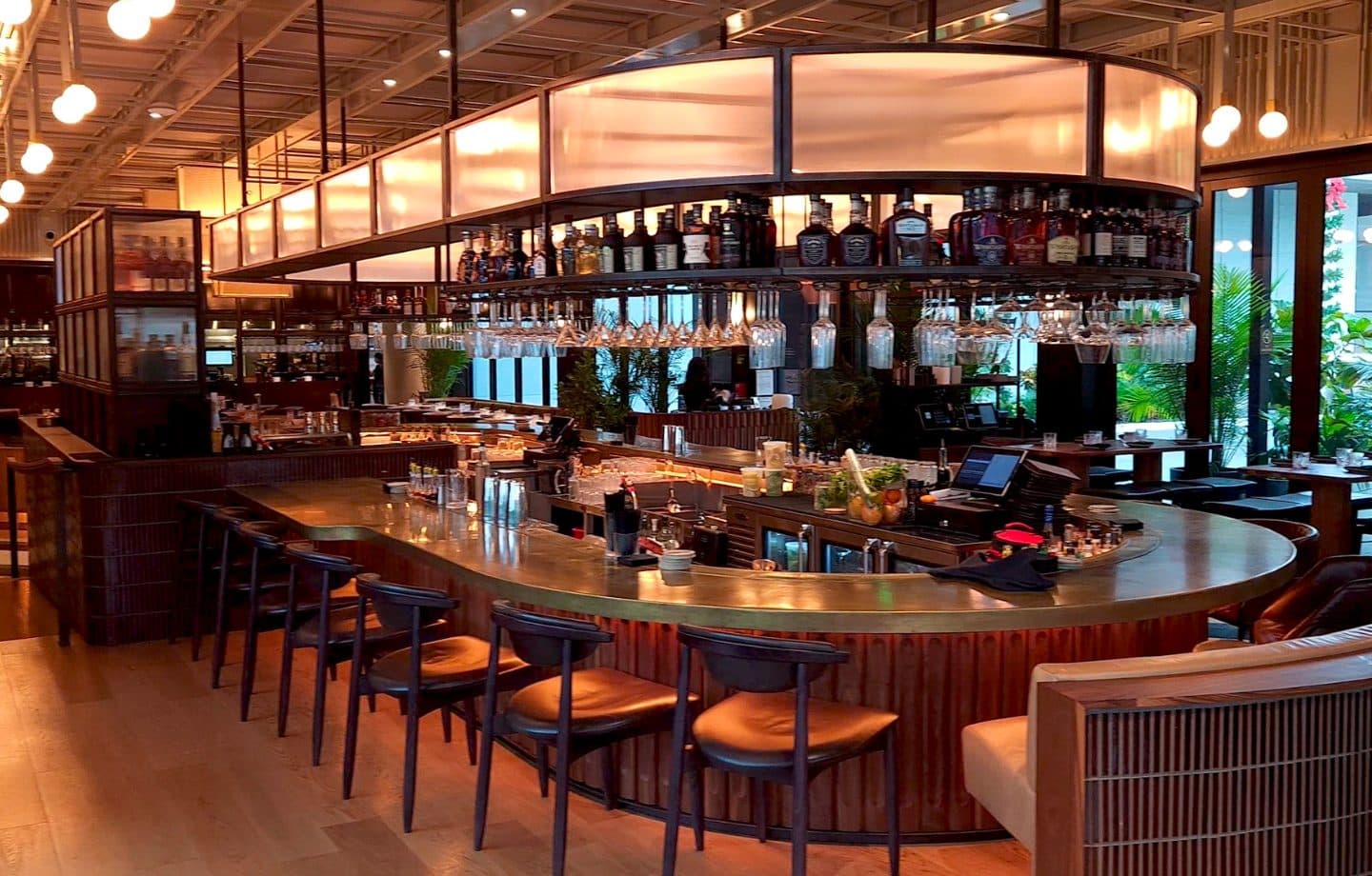 Union New American circular bar with fluted wood panels and brass top