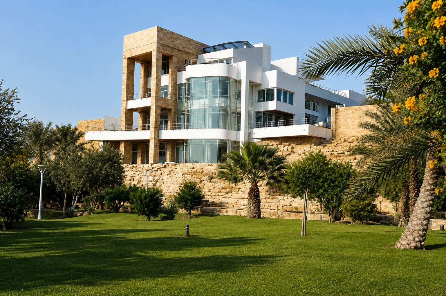 Wadi Hanifa Palace white modernist volumes over stone-terraced escarpment