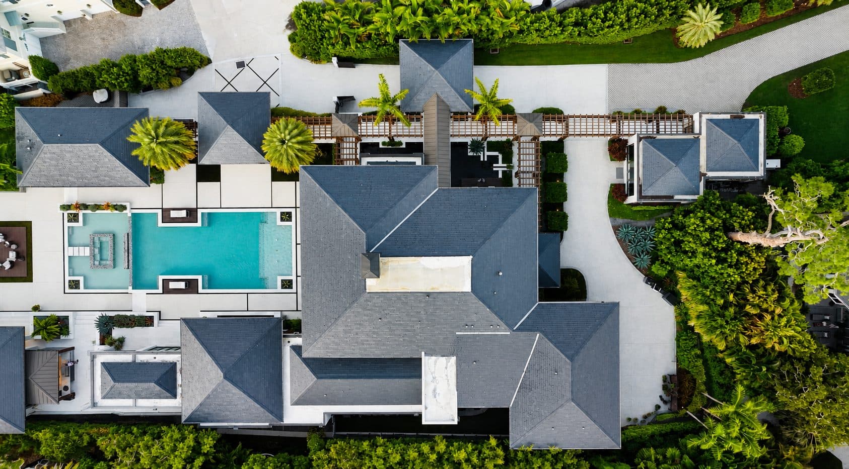 Imperial Villa aerial view of compound with pool court, pergola spine, and outbuilding pavilions