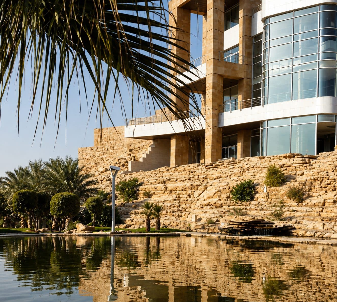 Wadi Hanifa Palace curved glass bay and stone terraces reflected in pool